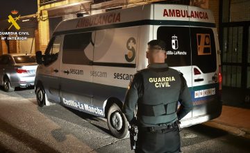 Agente de la Guardia Civil junto a una ambulancia durante una intervención.